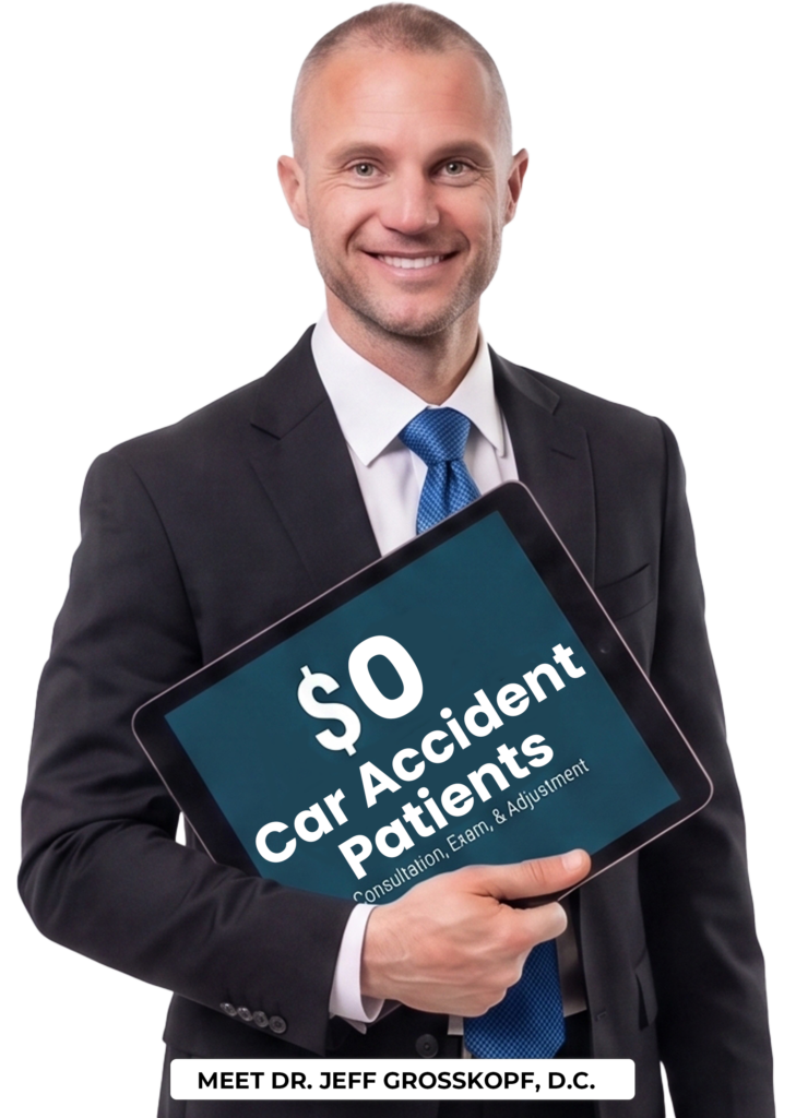 Dr. Jeff holding a new patient special coupon for car accident patients.