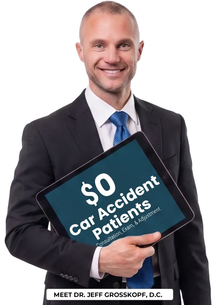 Dr. Jeff holding a new patient special coupon for car accident patients.